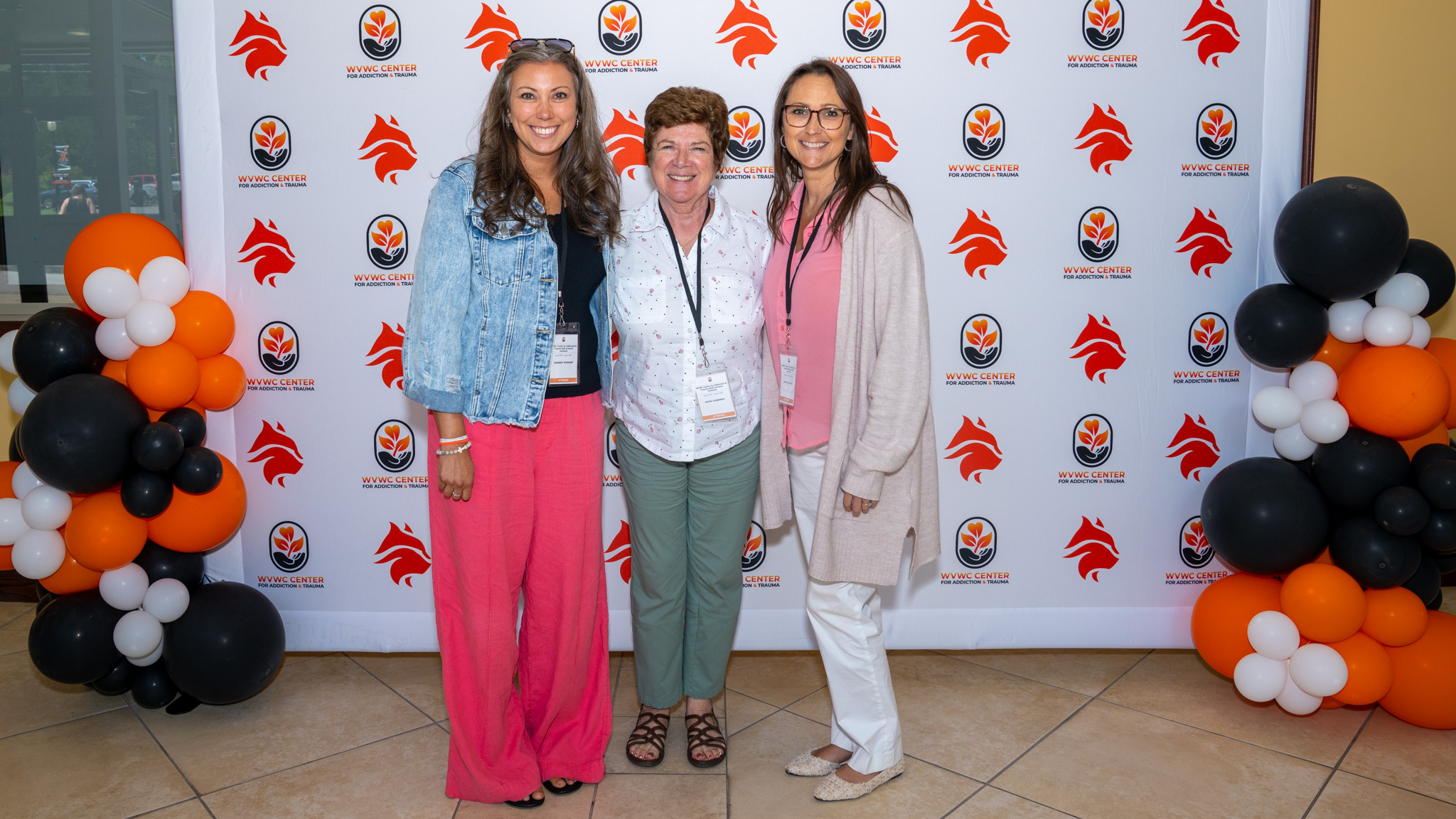 Three female attendees stop for a group photo at the 2026 Summer Institute hosted by the Center for Addiction and Trauma at West Virginia Wesleyan College.