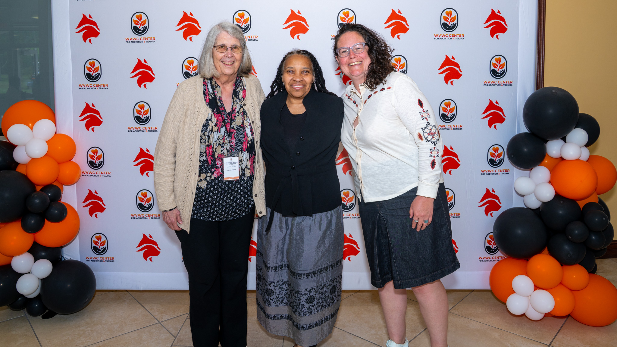 Three female attendees stop for a group photo at the 2026 Summer Institute hosted by the Center for Addiction and Trauma at West Virginia Wesleyan College.