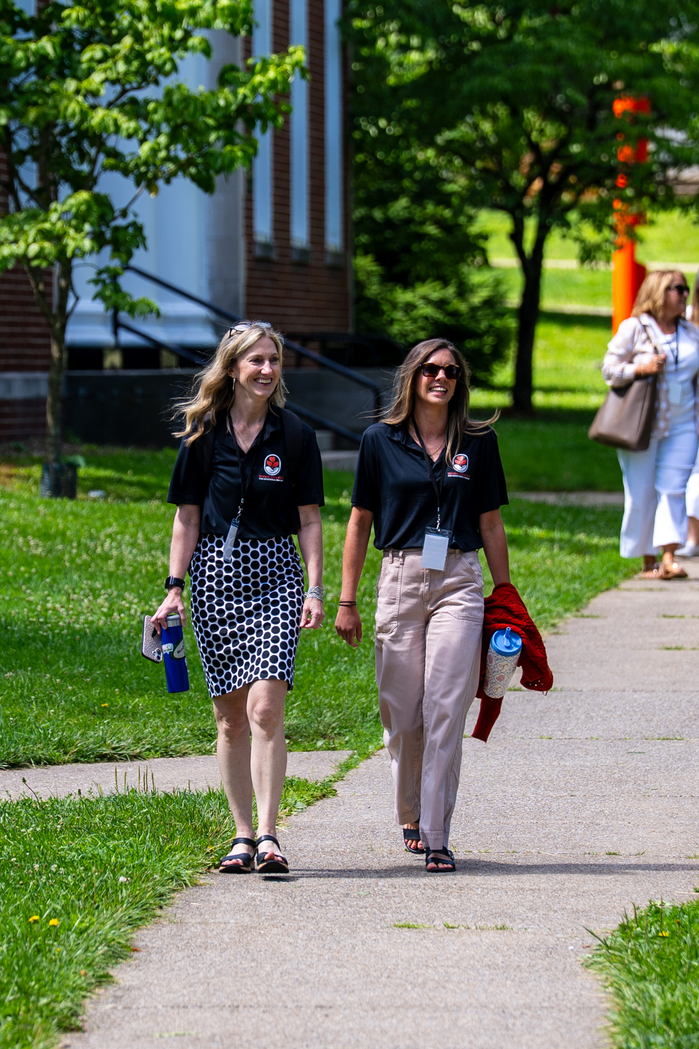 A picture of two attendees walking through the West Virginia Wesleyan campus during the 2026 Summer Institute hosted by the Center for Addiction and Trauma.